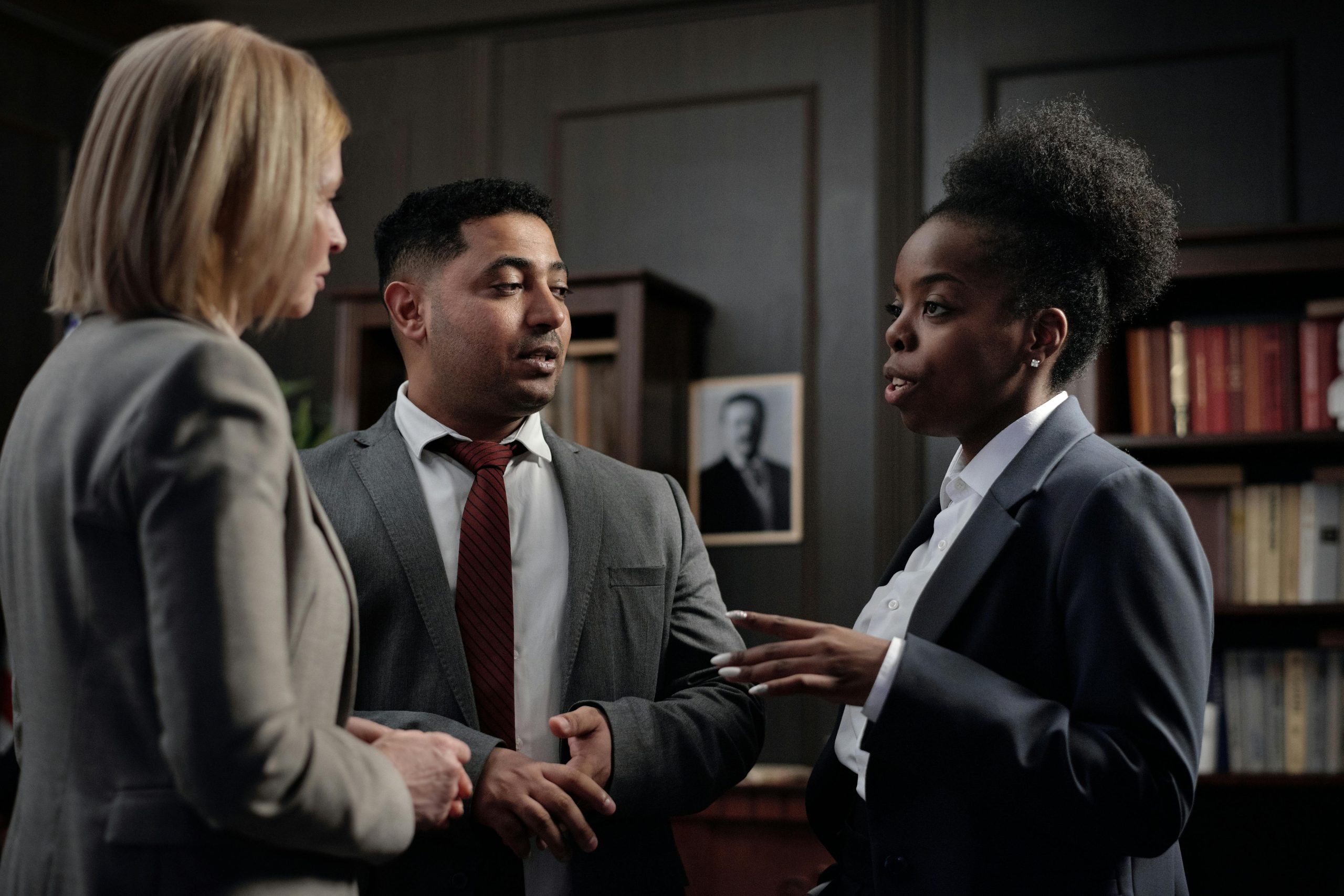 Diverse professionals engaged in strategic discussion in a law office setting.